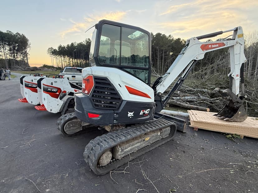 Excavator and compact track loader at a construction site