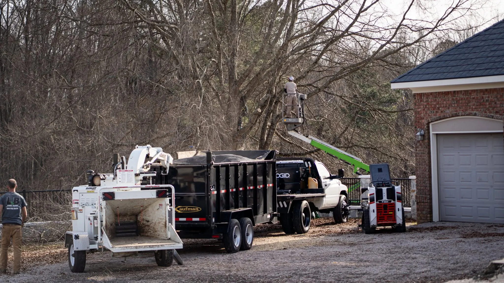 Tree trimming operation with workers and equipment